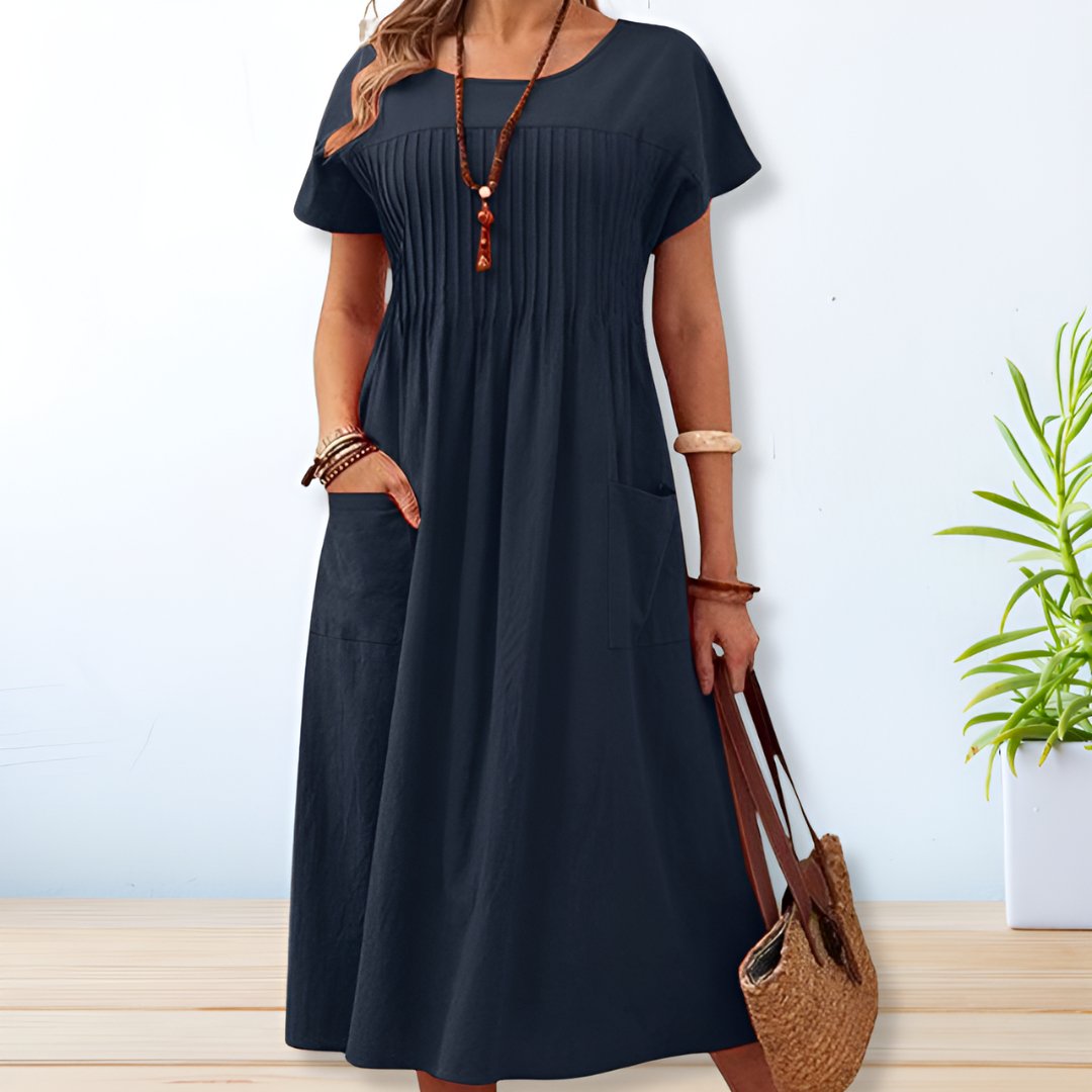 Women's relaxed fit pleated midi dress with pockets, a stylish and comfortable choice for casual outings.