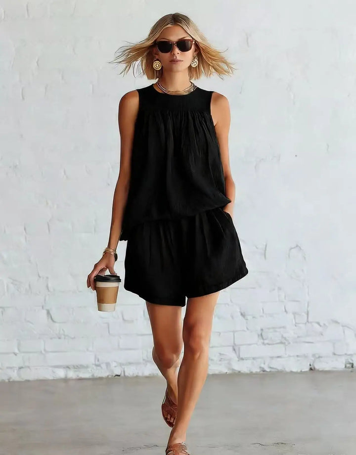 Sleeveless top and high-waisted shorts in a women's casual two-piece set, ideal for effortless summer style.