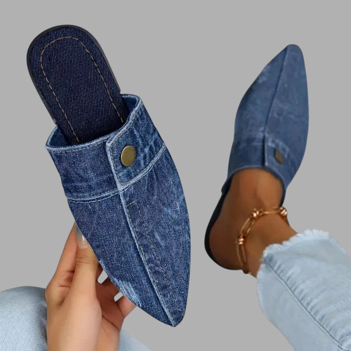 Black women's slip-on mule sandals, versatile flat footwear for a chic casual everyday style.