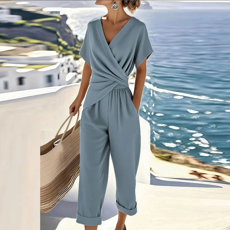 Stylish women's blue wrap wide-leg cropped jumpsuit. Comfortable day-to-evening one-piece for summer fashion.