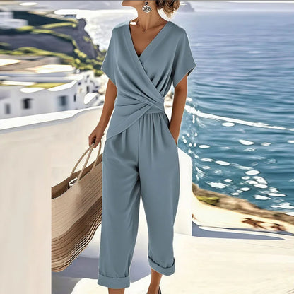 Stylish women's blue wrap wide-leg cropped jumpsuit. Comfortable day-to-evening one-piece for summer fashion.