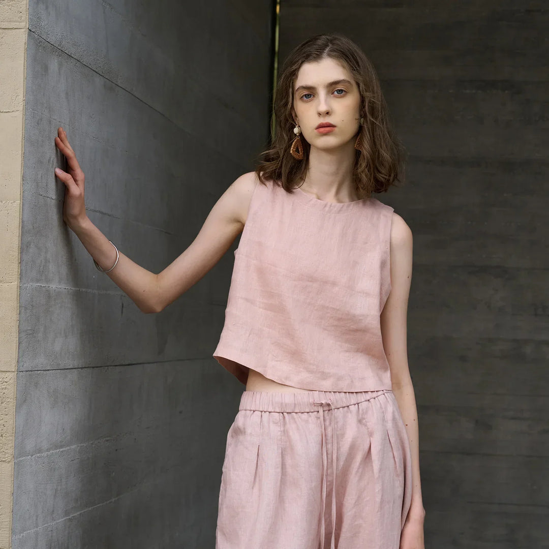 Women's chic asymmetric crop top with a sleeveless design & crew neck. Perfect for summer casual wear.