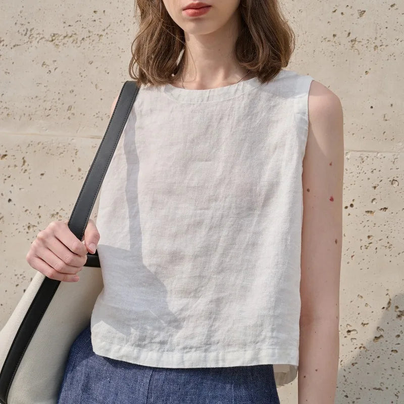 Stylish women's sleeveless crew neck asymmetric crop top, showcasing a modern, trendy look. Relaxed fit.
