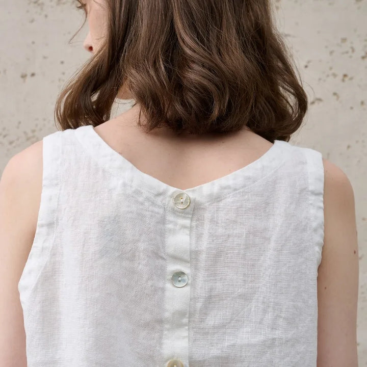 Chic women's crop top with an asymmetric hem, sleeveless design, and comfortable crew neck. Summer essential.