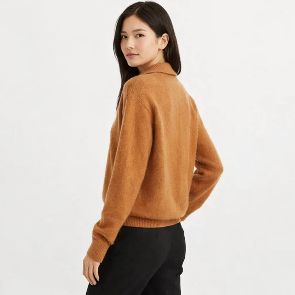 Cozy knit women's cardigan featuring an asymmetrical design & stylish buttons, ideal for winter warmth.