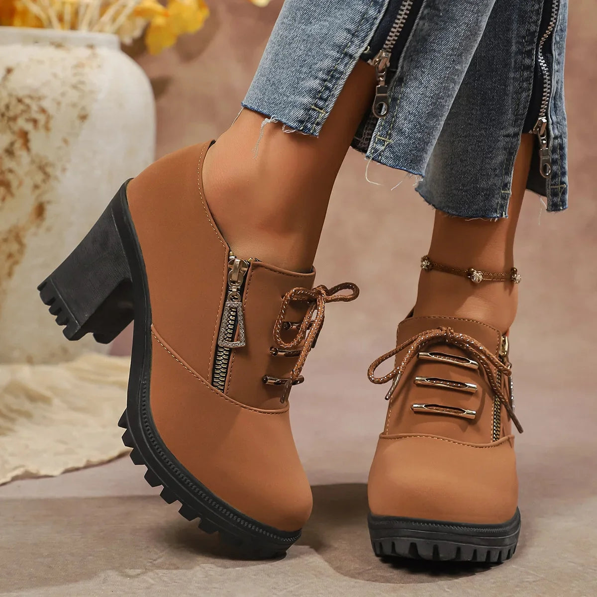 Close-up of brown women's block heel boots, highlighting orthopedic comfort & stylish design.