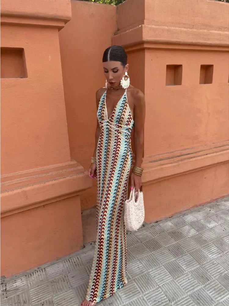 Boho maxi dress with vibrant chevron print. Chic open-back halter style for wedding guests or vacation.
