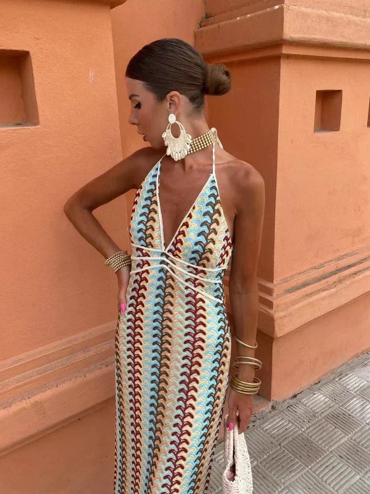 Elegant printed maxi wedding guest dress. Features a stylish halter neckline & open back. Perfect for summer.