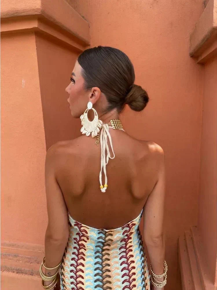 Chevron print boho maxi dress, elegant for wedding guests. Halter neckline and flowy skirt create a chic look.