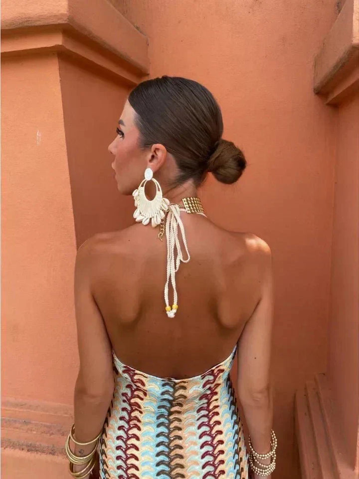 Chevron print boho maxi dress, elegant for wedding guests. Halter neckline and flowy skirt create a chic look.