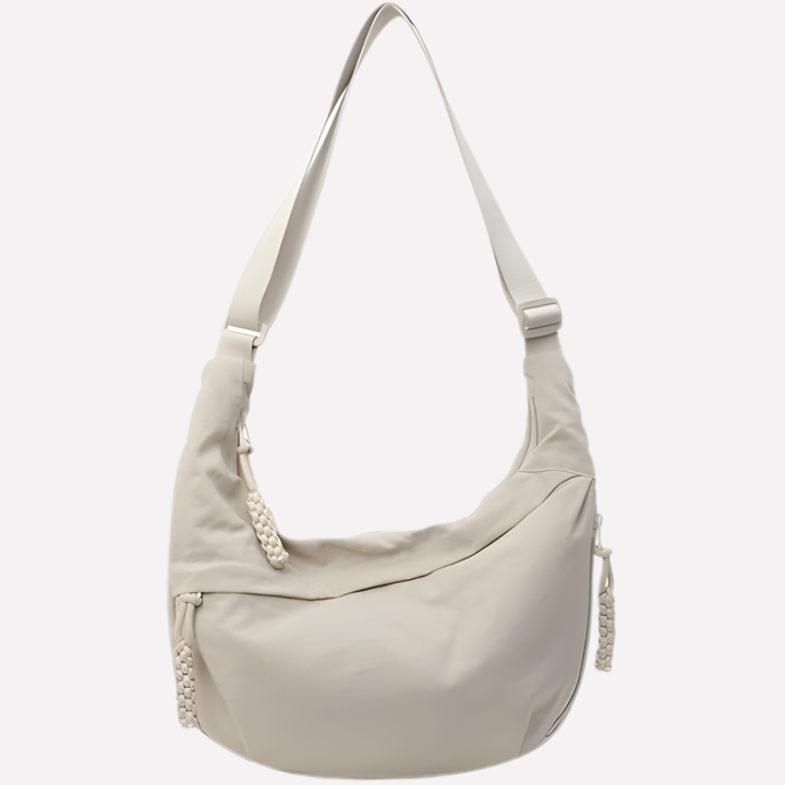 Women's chic crescent shoulder bag with elegant braided detail. Stylish everyday handbag for fashion-forward women.