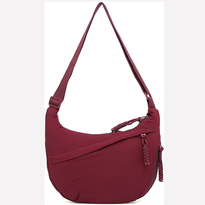 High-angle view of a women's crescent shoulder bag, highlighting its spacious design and chic braided accent.