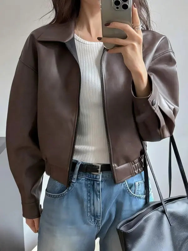 Stylish women's cropped jacket. Modern fit outerwear with structured collar, offering a chic and versatile fashion statement.