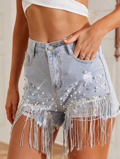 Casual women's blue denim shorts featuring stylish tassels, ideal for summer outfits.