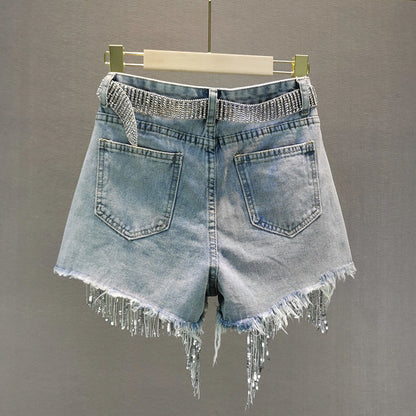 Stylish women's blue denim shorts with decorative tassels, great for casual summer wear.