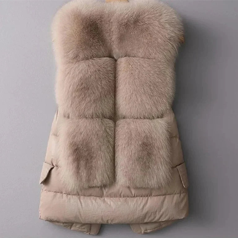 Warm women's quilted vest with luxurious faux fur trim. Elegant sleeveless jacket for stylish winter layering.