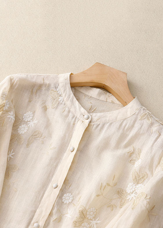 Fashionable women's top: floral print, button-front, unique patchwork design.