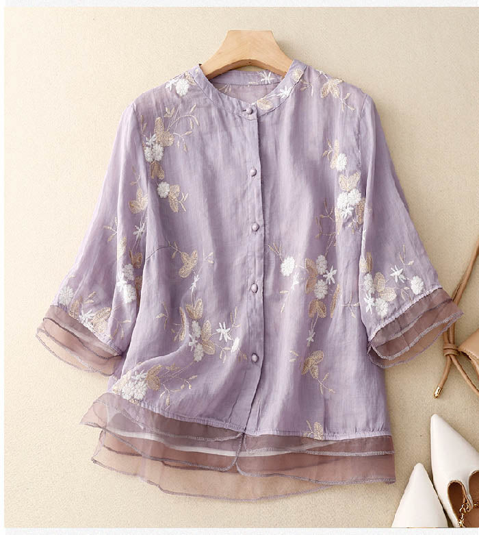Stylish women's blouse with intricate floral pattern & smart buttoned patchwork top.