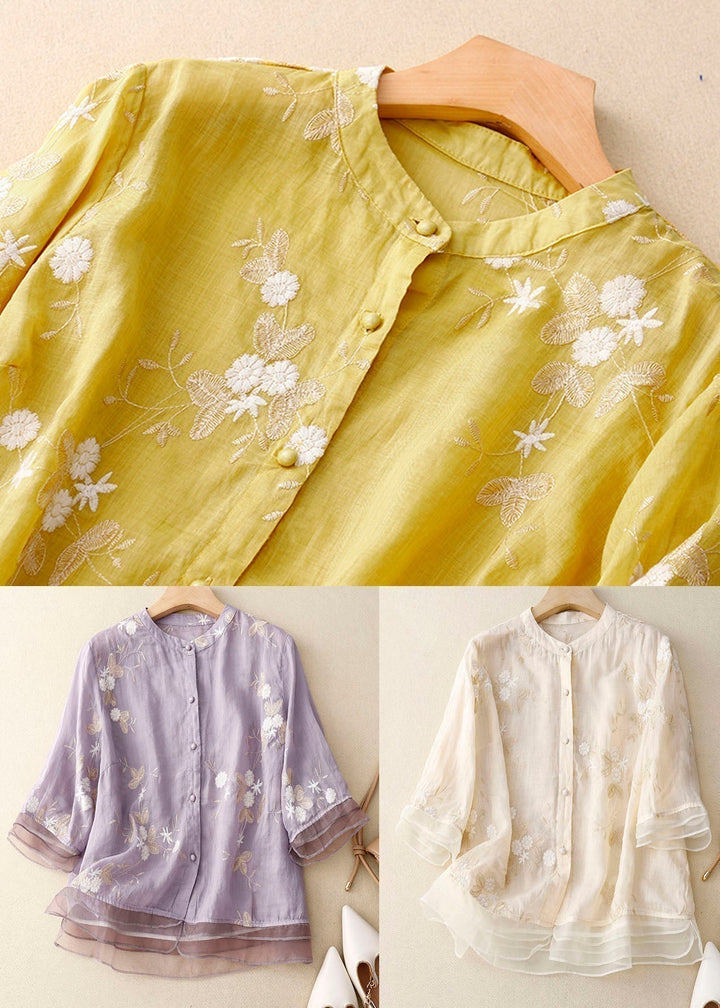 Women's elegant long-sleeve floral blouse with chic button details & modern patchwork.