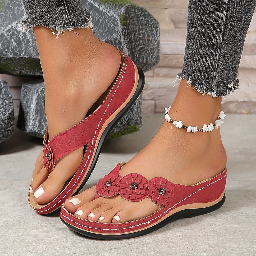 Elegant women's platform wedge sandals with floral pattern, chic summer footwear.
