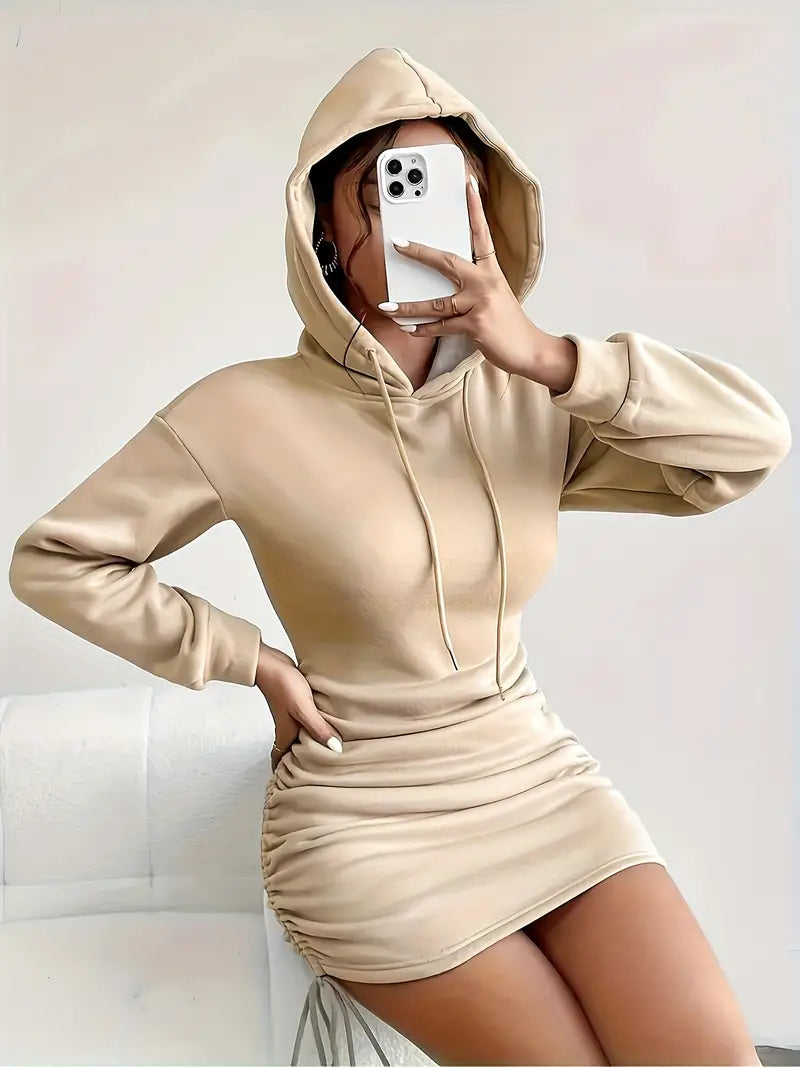 Comfortable women's ruched hoodie mini dress, ideal for casual spring fashion. Adjustable sides.