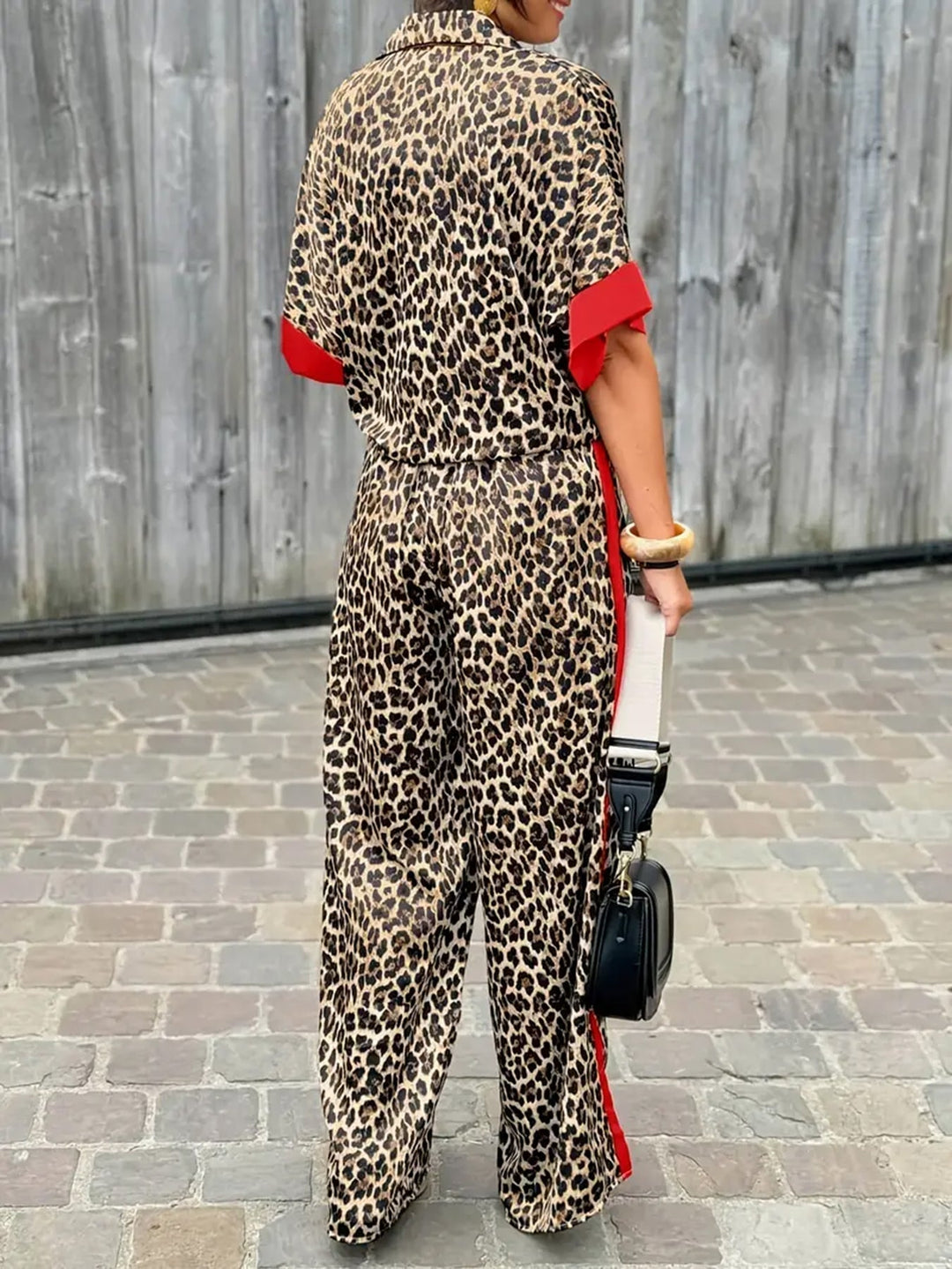 Stylish women's jumpsuit with trendy leopard print, V-neck, and wide leg design. Ideal for day to night.