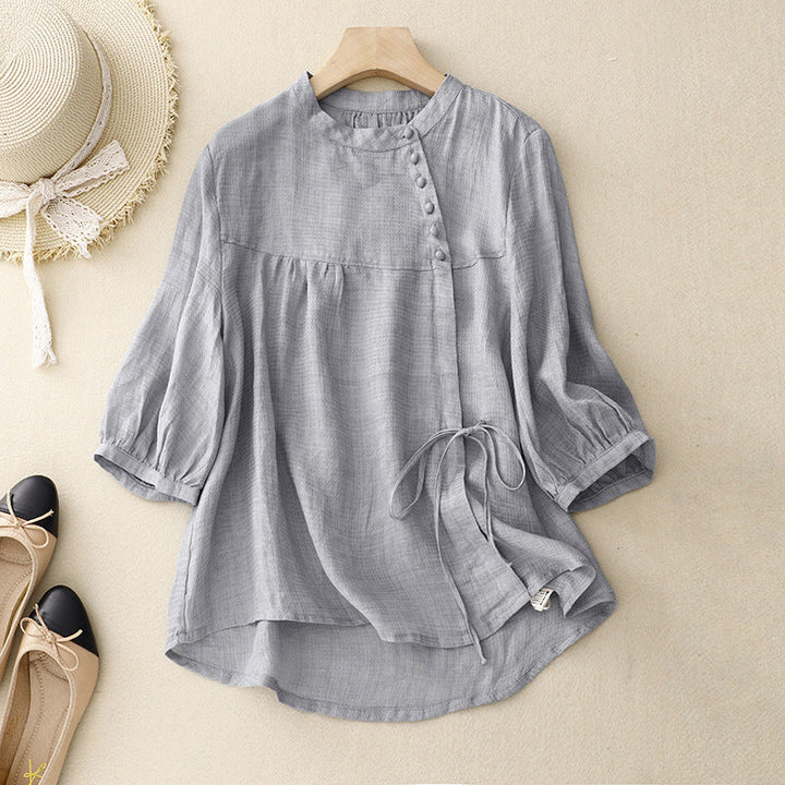 Women's chic light gray wrap blouse with elegant puffed sleeves, perfect for spring/summer fashion.