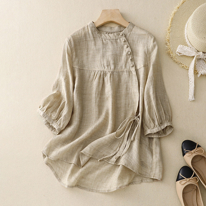 Comfortable beige women's wrap blouse with trendy puff sleeves, ideal for a chic spring or summer look.