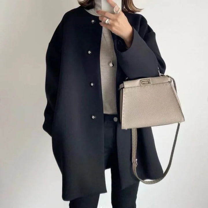 Elegant women's oversized button coat in a minimalist style, ideal for fall & winter fashion. Features large buttons.