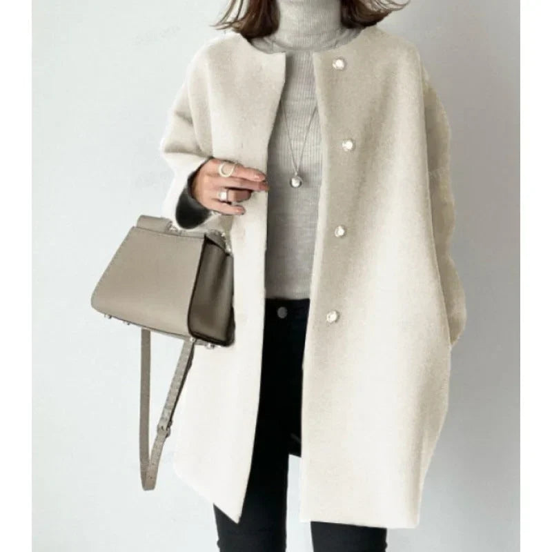 Stylish women's minimalist button coat, oversized for a modern look. Essential fall/winter fashion outerwear.