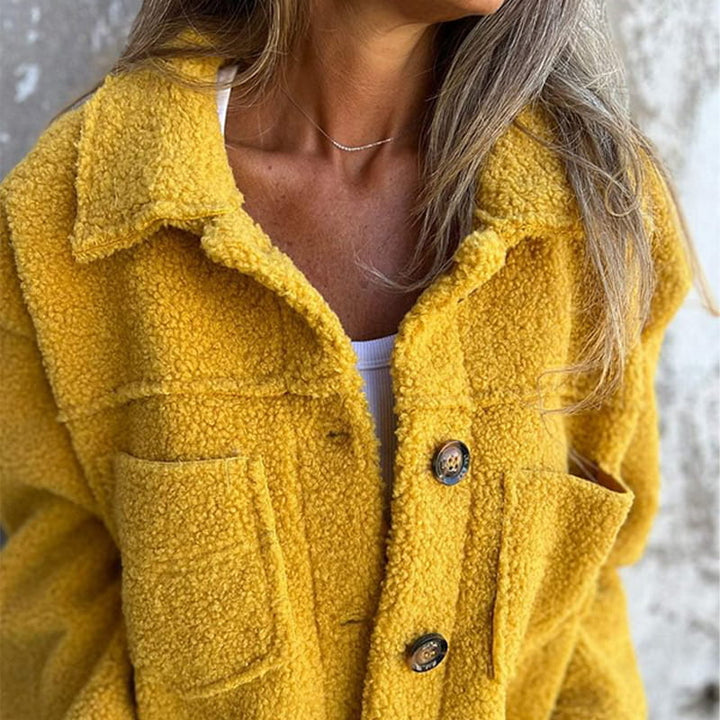Woman wearing a chic notch collar button-up autumn coat, showcasing elegant fall fashion.