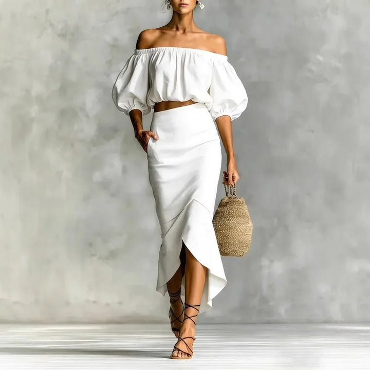Elegant two-piece women's off-shoulder skirt set with puff sleeve crop top & wrap midi for brunch or vacation.