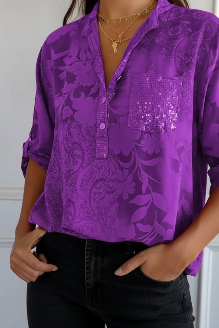 Chic women's printed long-sleeve blouse with a front pocket. Versatile top for casual outfits or elegant workwear.