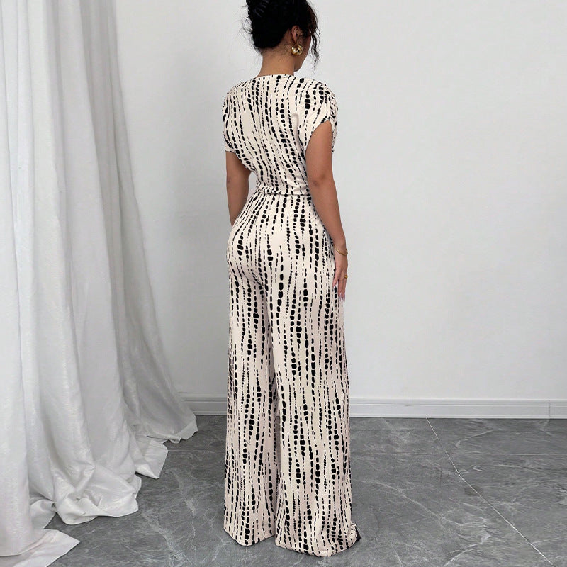 Fashionable women's one-shoulder wide leg jumpsuit, featuring a vibrant print & chic belt, perfect for summer parties.