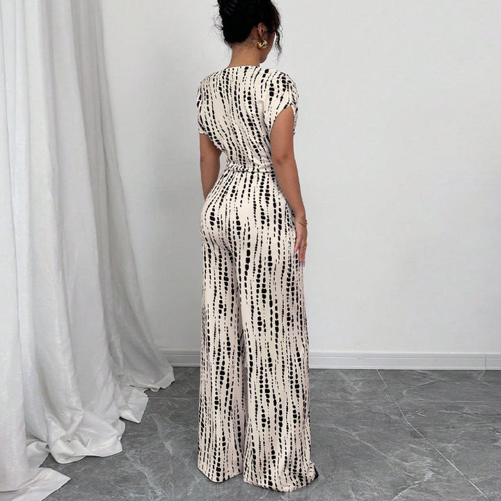 Fashionable women's one-shoulder wide leg jumpsuit, featuring a vibrant print & chic belt, perfect for summer parties.