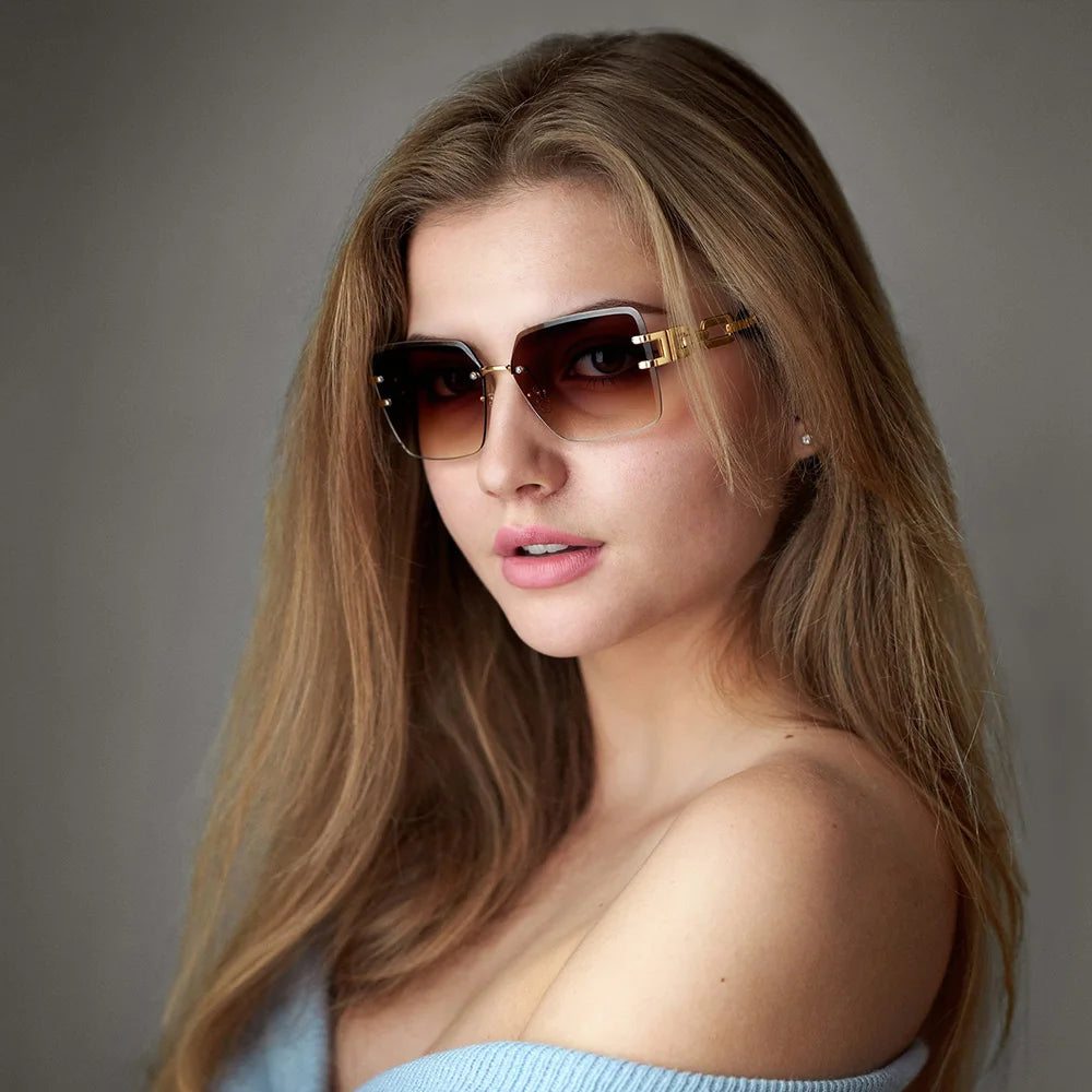 Contemporary women's rimless sunglasses with elegant chain link detail, a chic fashion accessory for UV400.