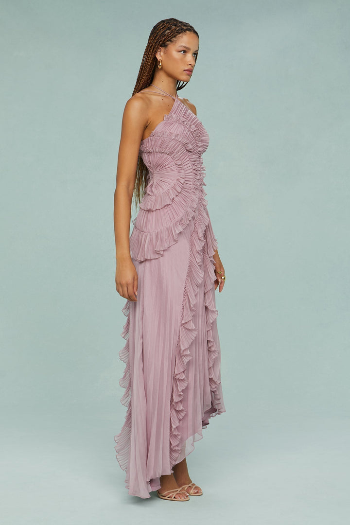 Long women's halter maxi dress, a chic ruffle design suitable as a wedding guest outfit.