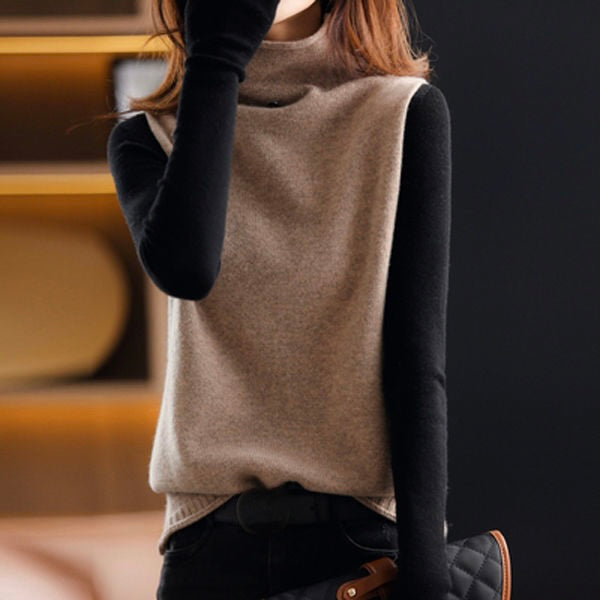 Woman wearing a sleek sleeveless turtleneck vest. A fashionable high neck top for versatile casual and elegant styling.