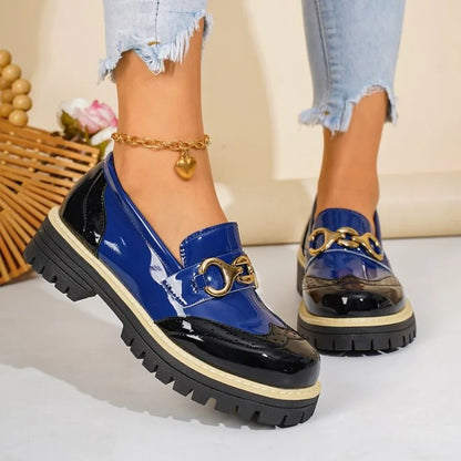 White women's loafers with a chic gold horsebit detail, offering elegant footwear for versatile comfort.