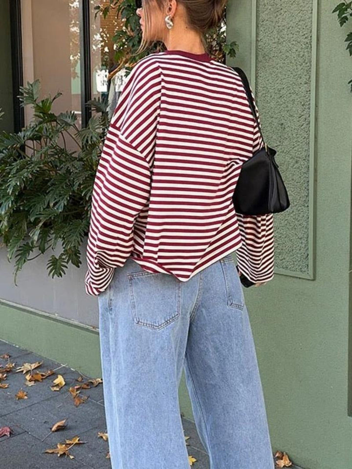 Chic women's striped bell sleeve top. Elegant women's sweater with a modern design, ideal for a statement outfit.