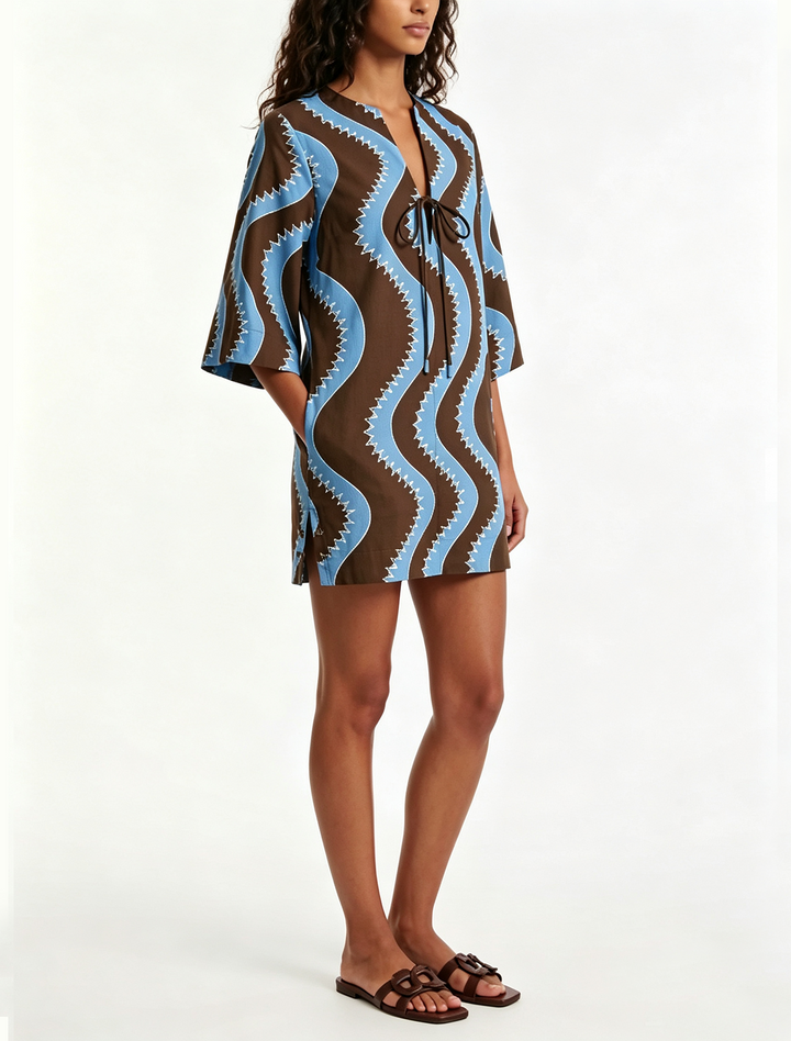 Stylish blue black wave print mini dress. Features collared button front & elbow sleeves for summer fashion.