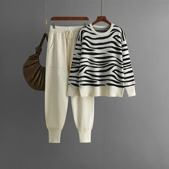 Folded women's zebra knit loungewear set, showing the soft fabric and bold pattern of the matching pieces.
