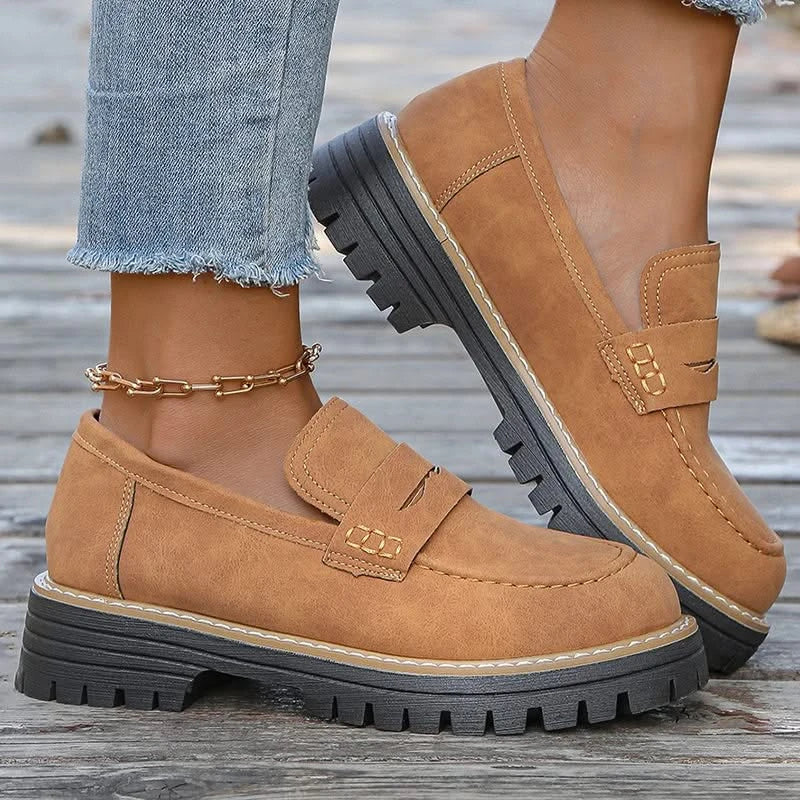 Women's chunky platform loafers, stylish black slip-on fashion footwear for everyday comfort.