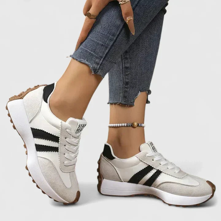 Comfortable women's chunky sole running shoes with supportive design. Lace-up athletic trainers for sporty gym & workout.