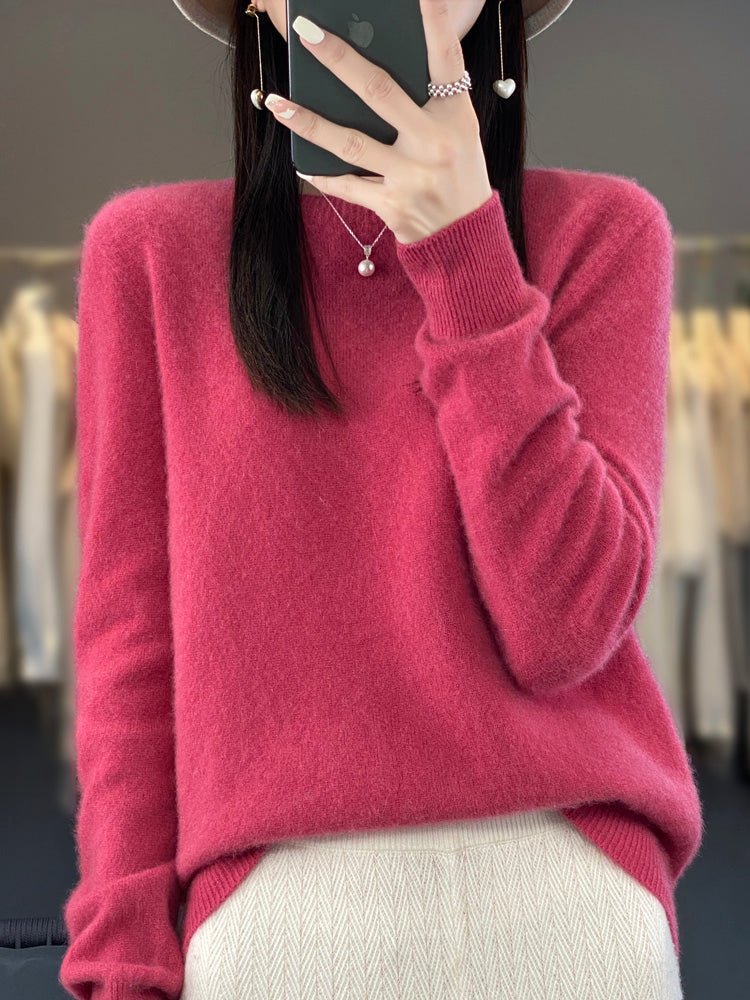 Model wearing a cozy women's round neck pullover, long sleeve, styled casually.