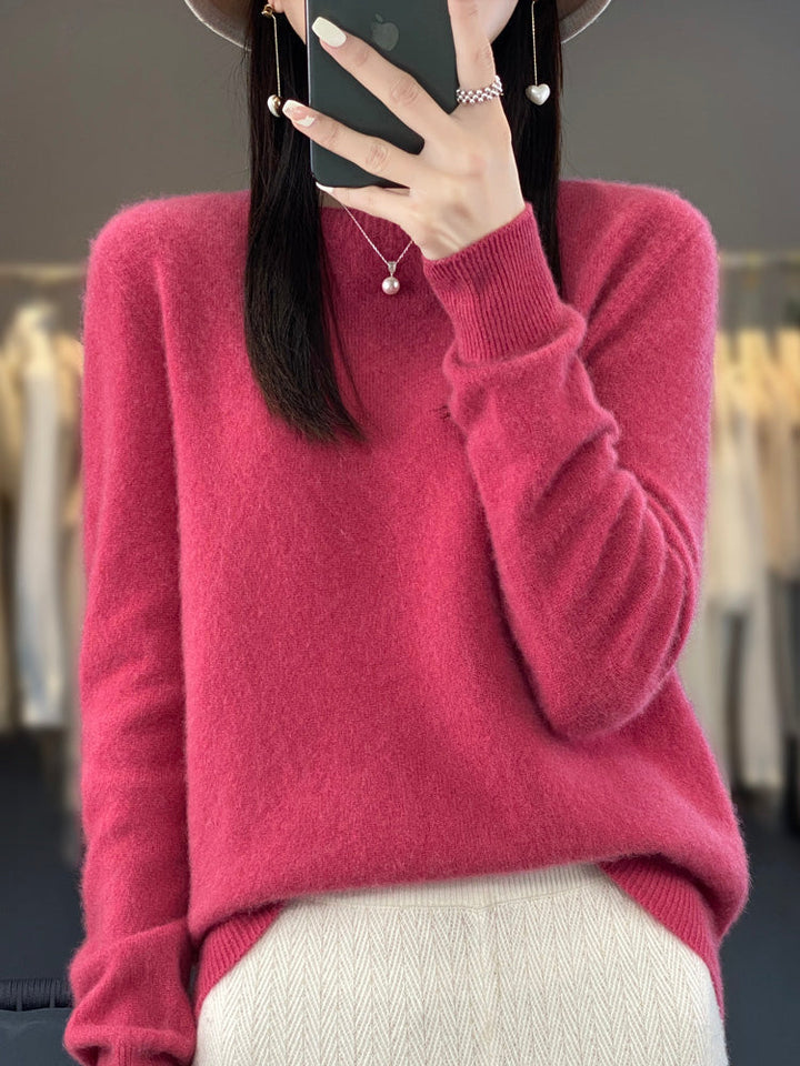 Model wearing a cozy women's round neck pullover, long sleeve, styled casually.