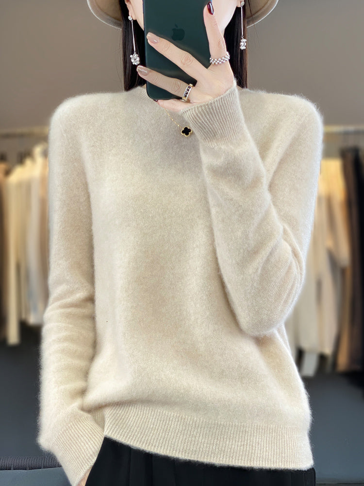 Flat lay of a women's classic round neck sweater, long sleeve, highlighting its texture.