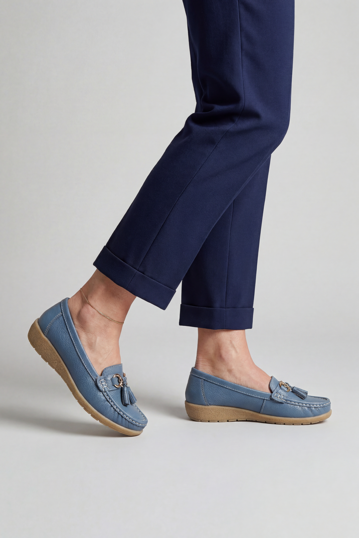 Close-up of soft upper material on comfortable women's slip-on loafers with classic design.