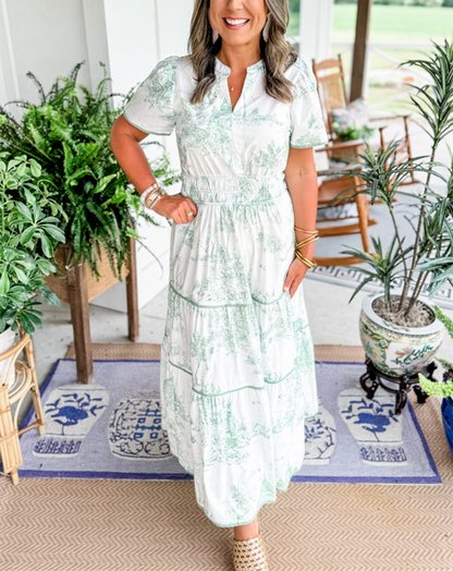 Woman moving in a long, flowing Toile Maxi Dress, emphasizing its elegant movement for summer events.
