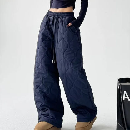 Cozy women's quilted trousers, featuring a wide leg & comfortable bottoms, suitable for various casual chic outfits.